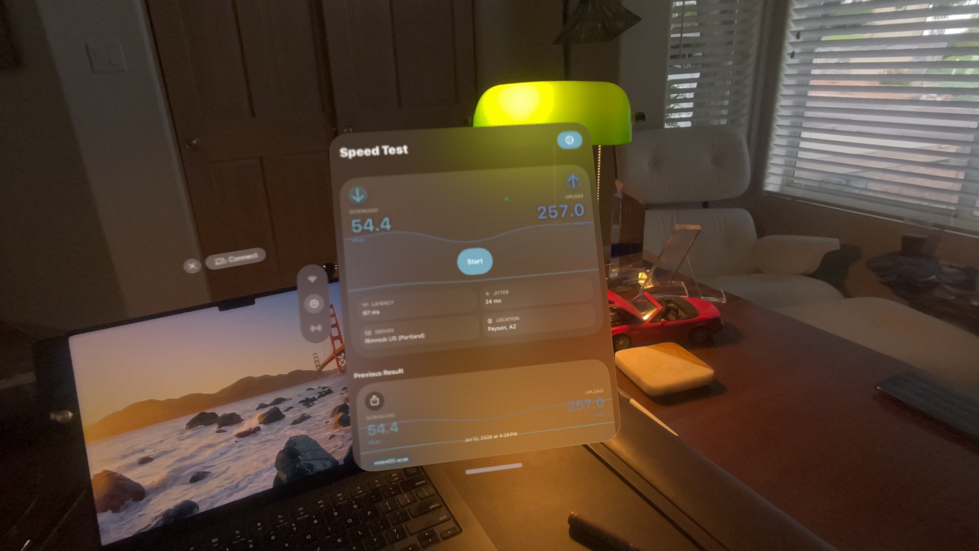 WiFiMaster's Speed Test running natively on Apple Vision Pro, floating over a desk in passthrough
